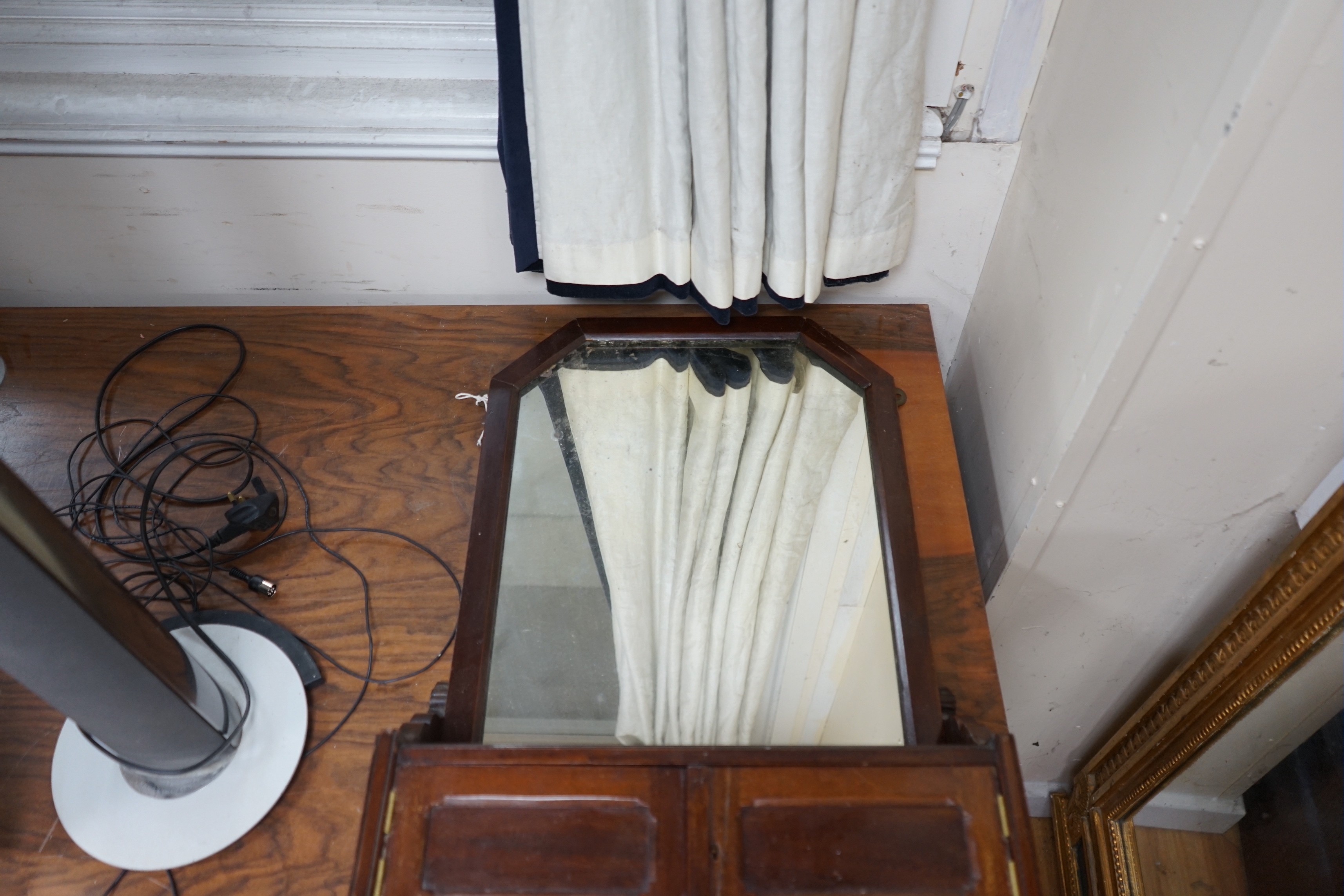 A 19th century German carved oak and beech spinning chair and an Edwardian wall mirror with hanging rail.